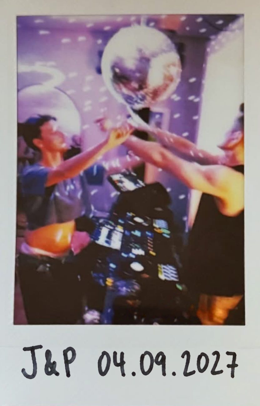 Jacob and Peter at the decks, reaching up to a mirror ball. An Instax print with J&P 04.09.2027 written in the white border.